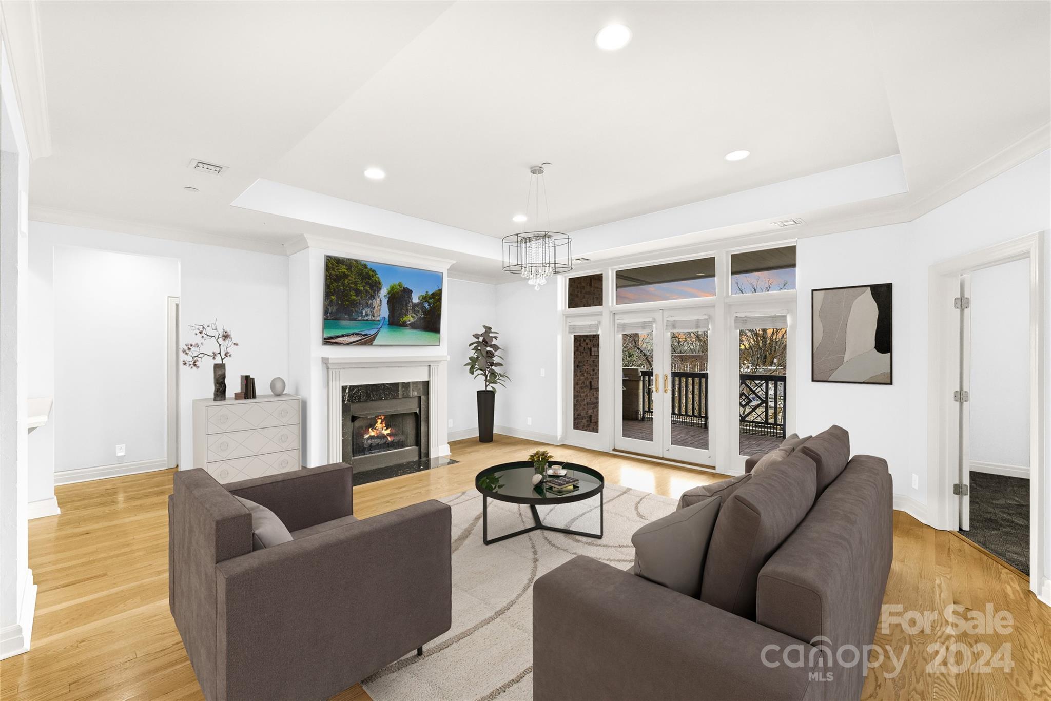 a living room with furniture a fireplace and a large window