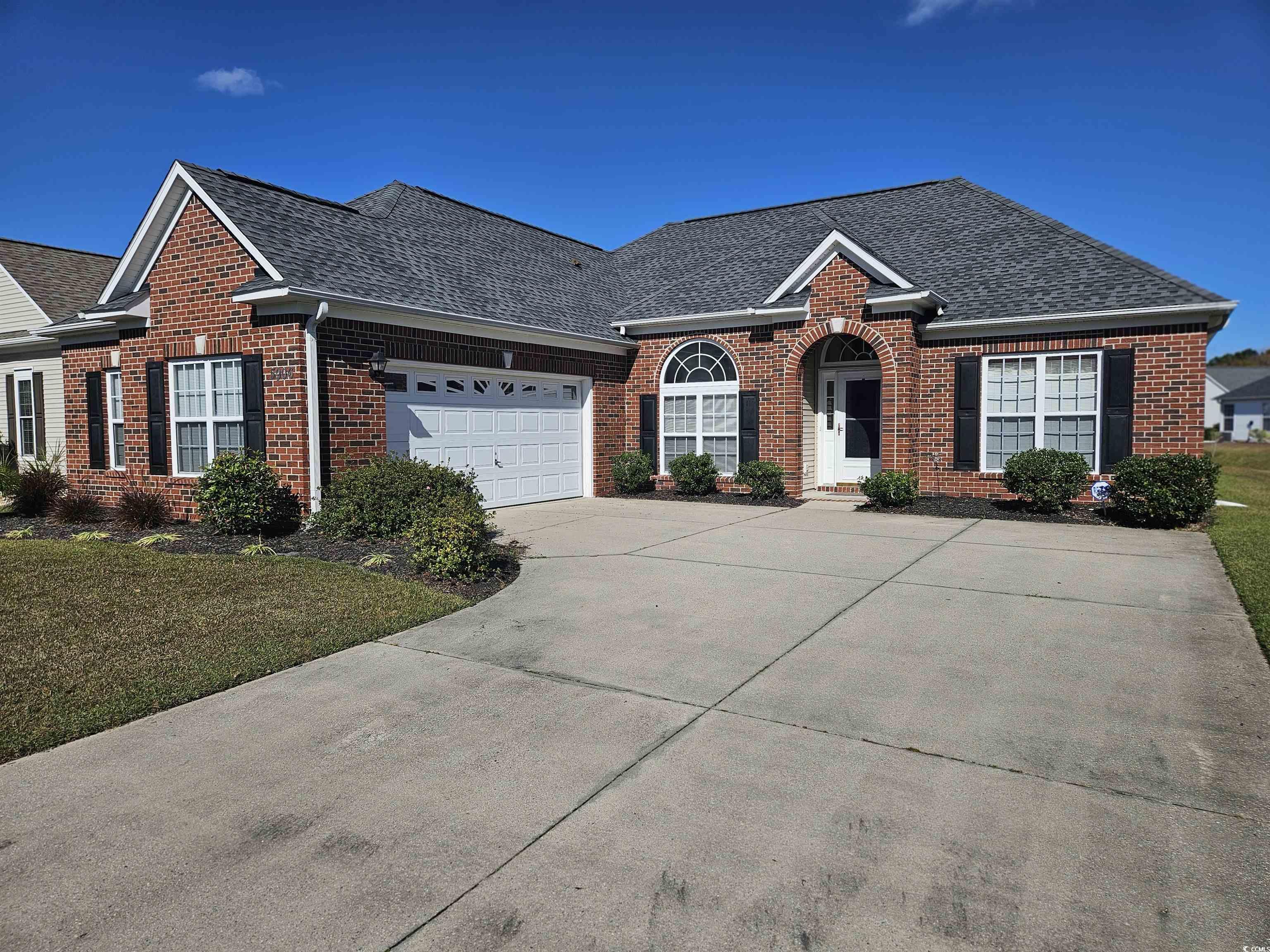 View of front of house featuring a garage and a fr