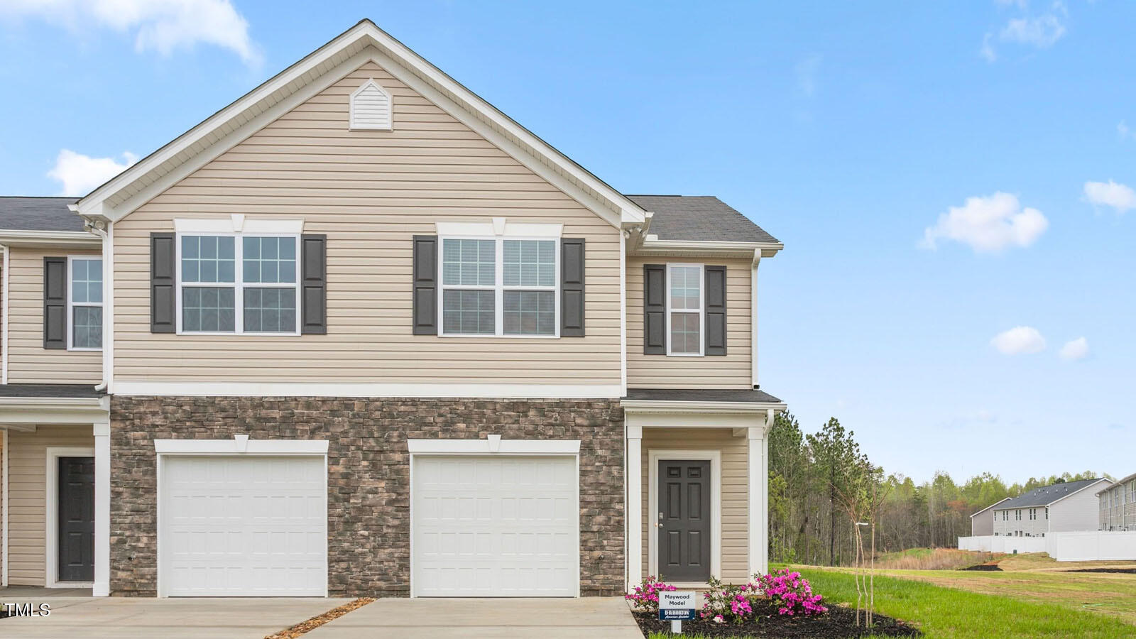 a view of a house with a yard and garage