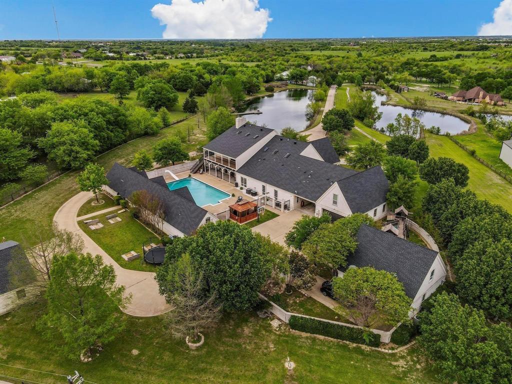 an aerial view of residential houses with outdoor space and swimming pool