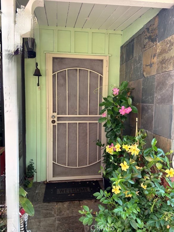 a front view of a house with a flower garden