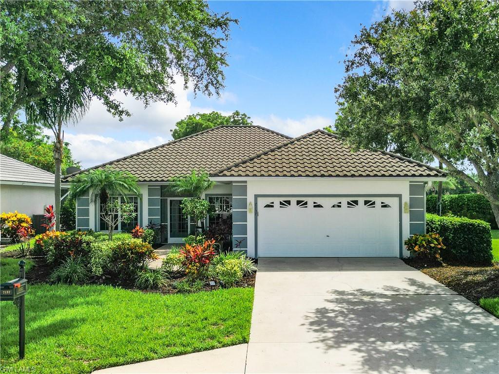 View of front of house featuring a front yard and a garage