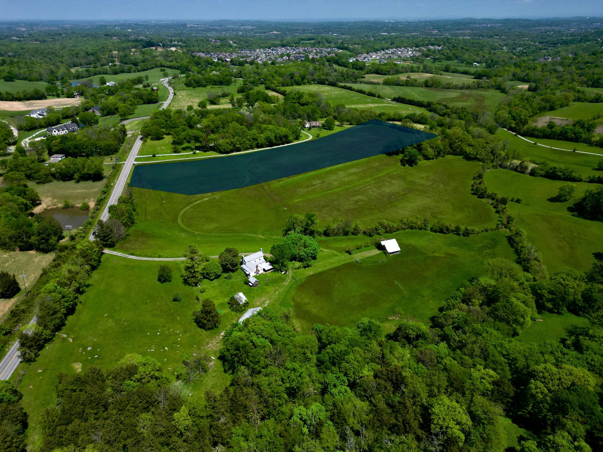 an aerial view of a forest with houses