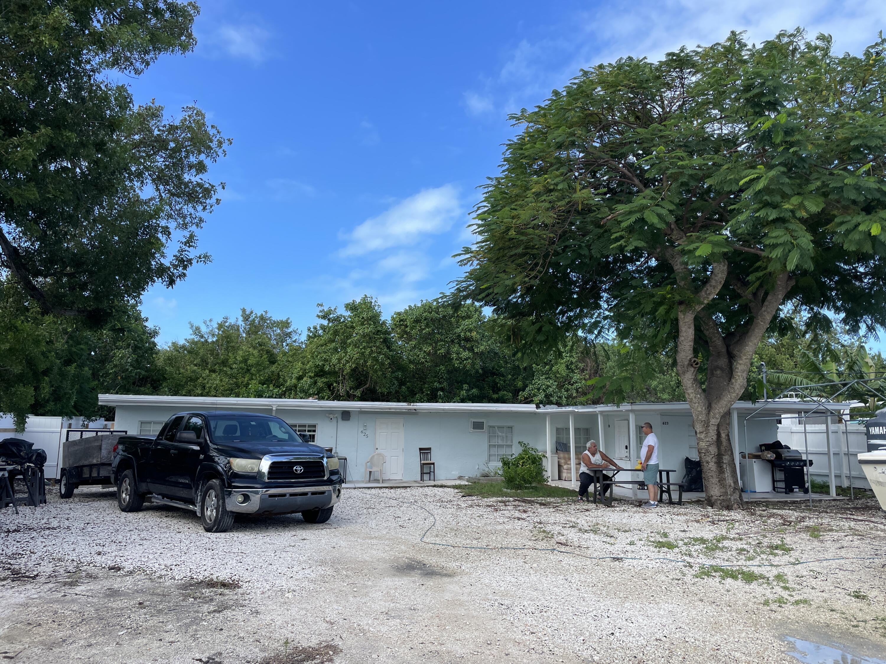 a view of backyard with car parked