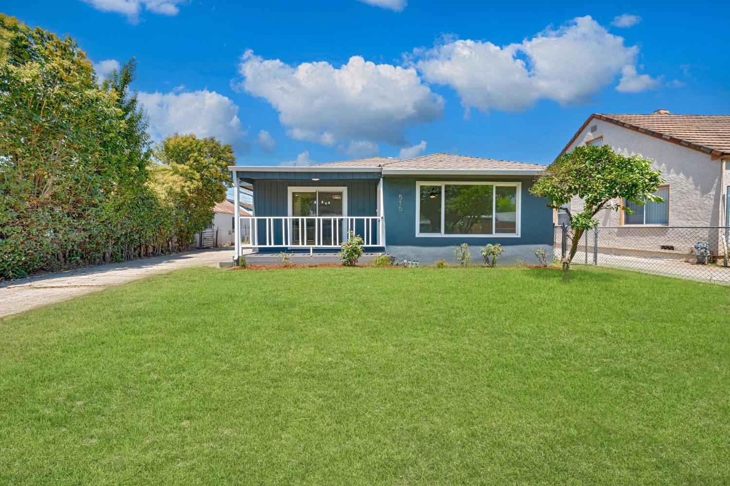 a view of a house with a backyard