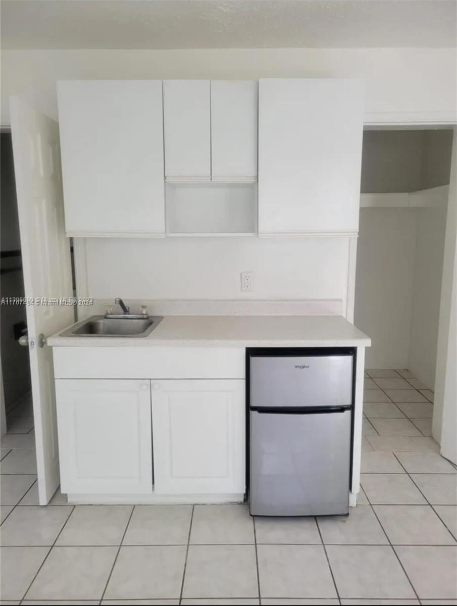 a kitchen with white cabinets