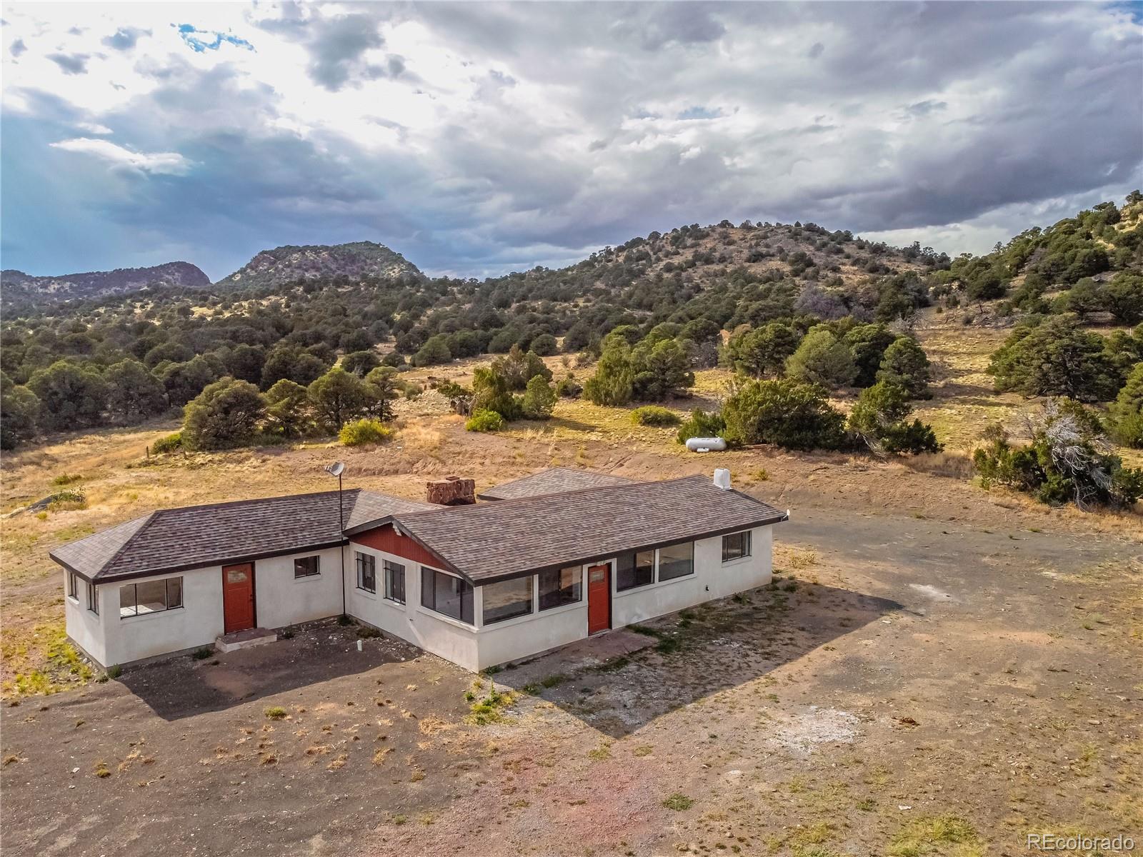 a view of a big house with a mountain in the background