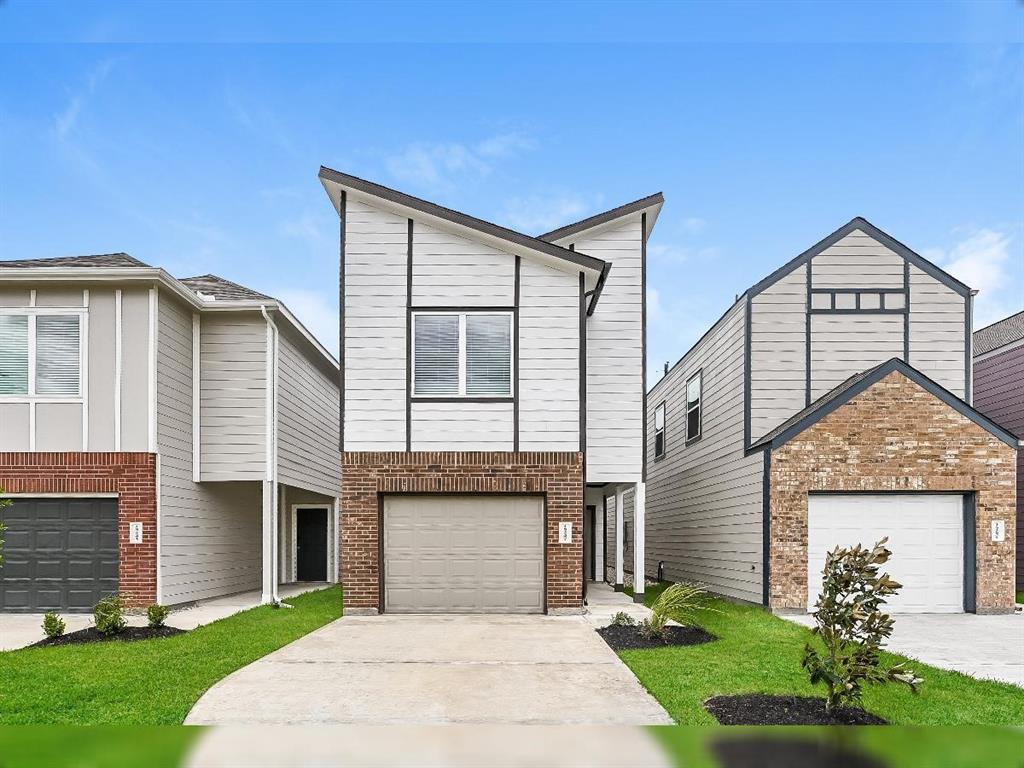 a front view of a house with a garden and yard