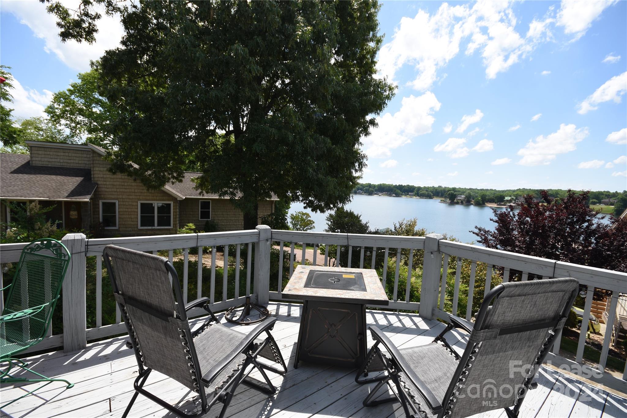 a view of a roof deck with furniture