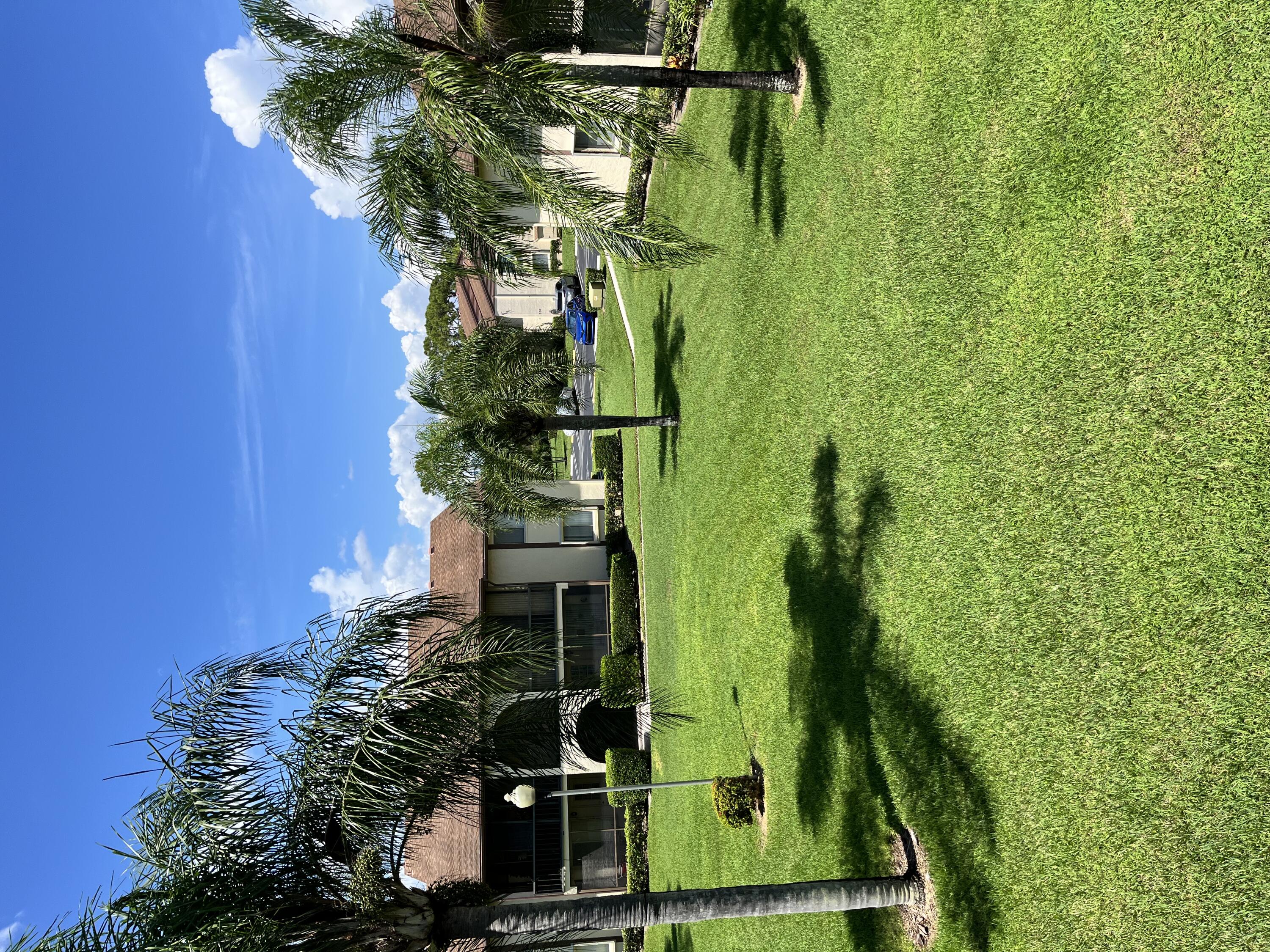 a view of a park with a house in the background