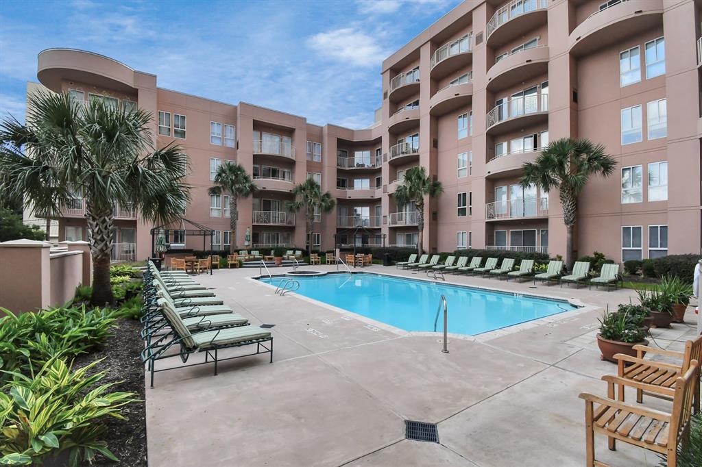 a swimming pool with outdoor seating and yard