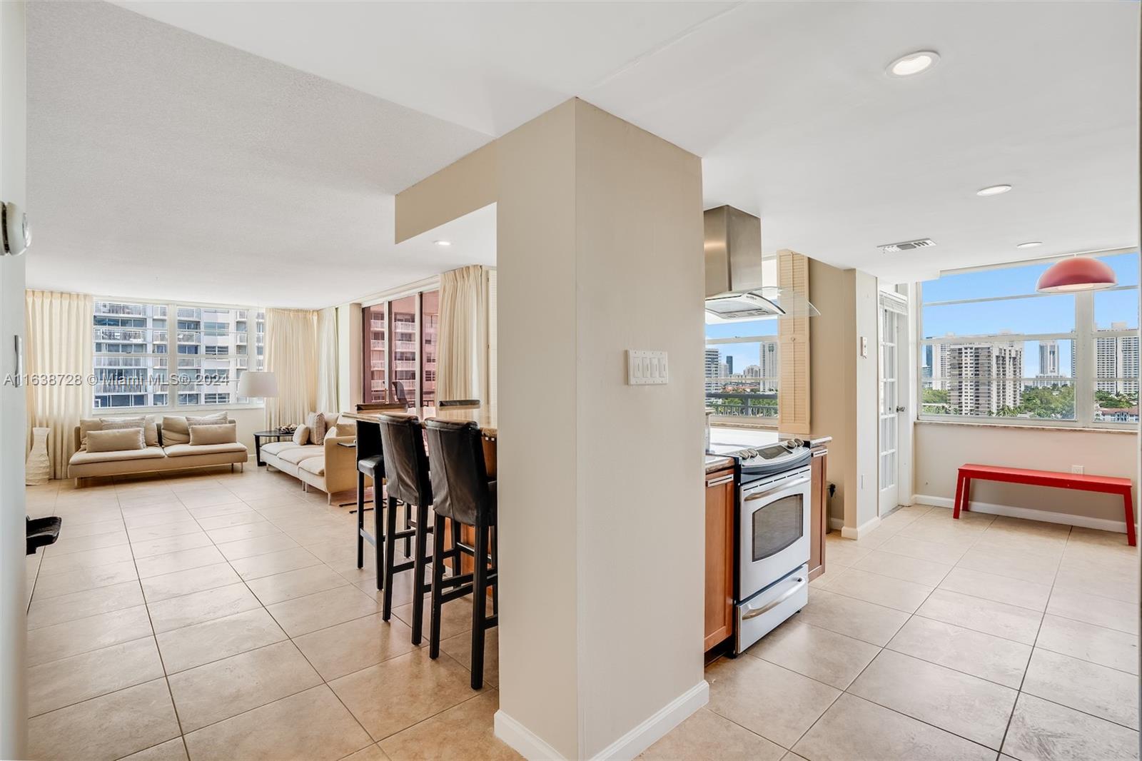 a kitchen with stainless steel appliances kitchen island granite countertop a refrigerator and cabinets