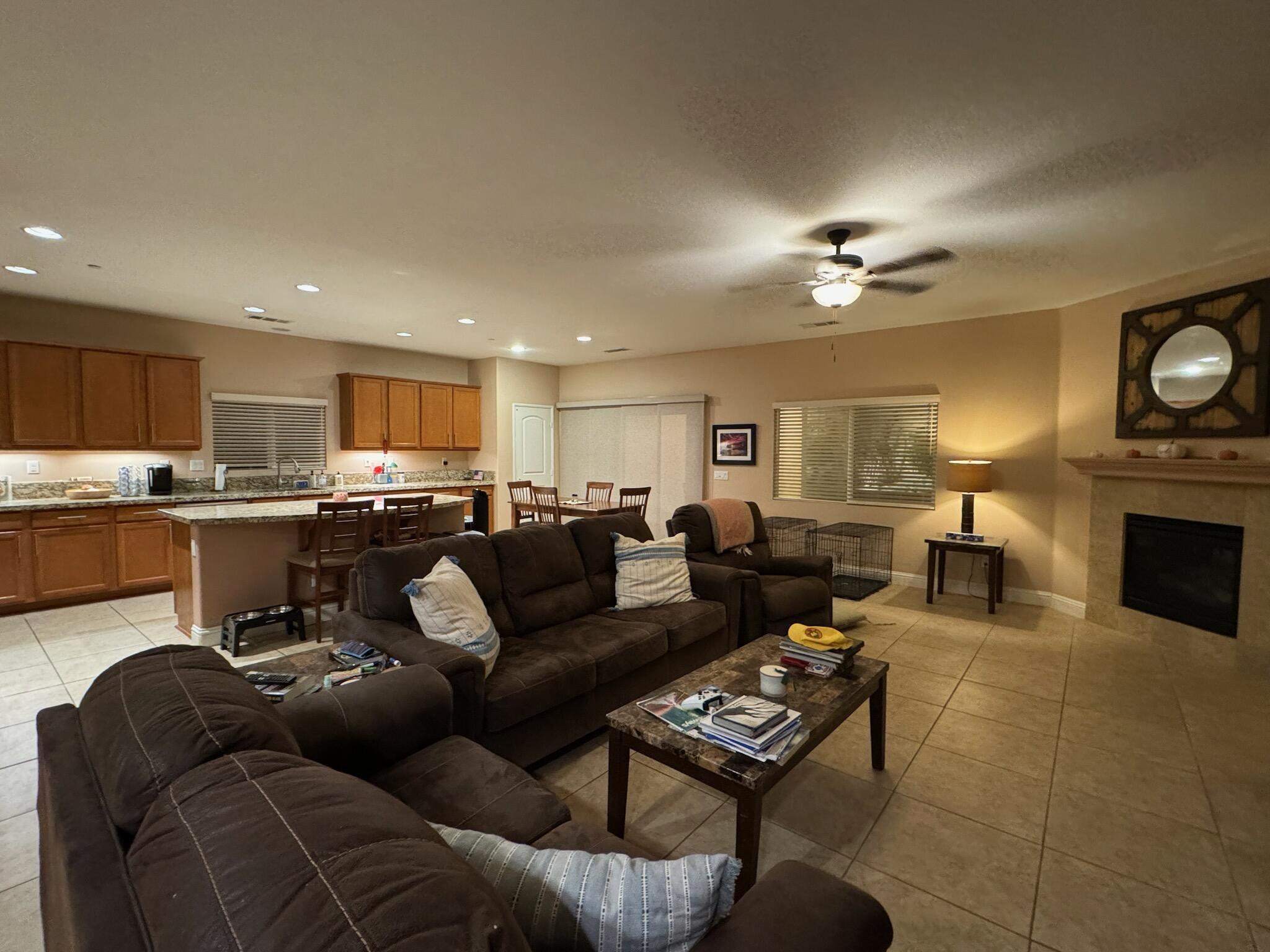 a living room with furniture kitchen view and a fireplace