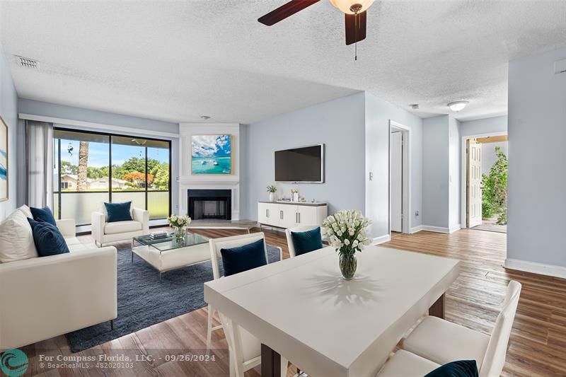 a living room with fireplace furniture and a flat screen tv