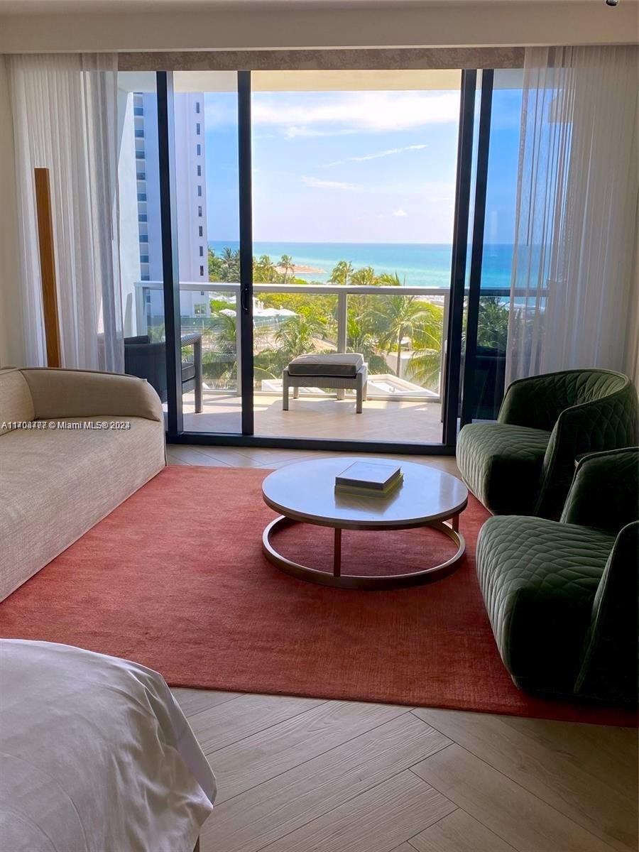 a living room with furniture and large windows