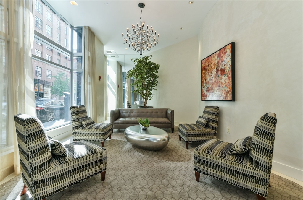 a living room with furniture and a chandelier