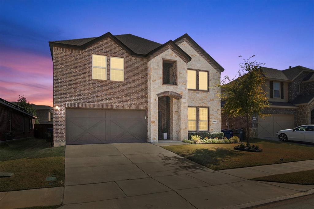 View of front of house with a yard and a garage (virtual)