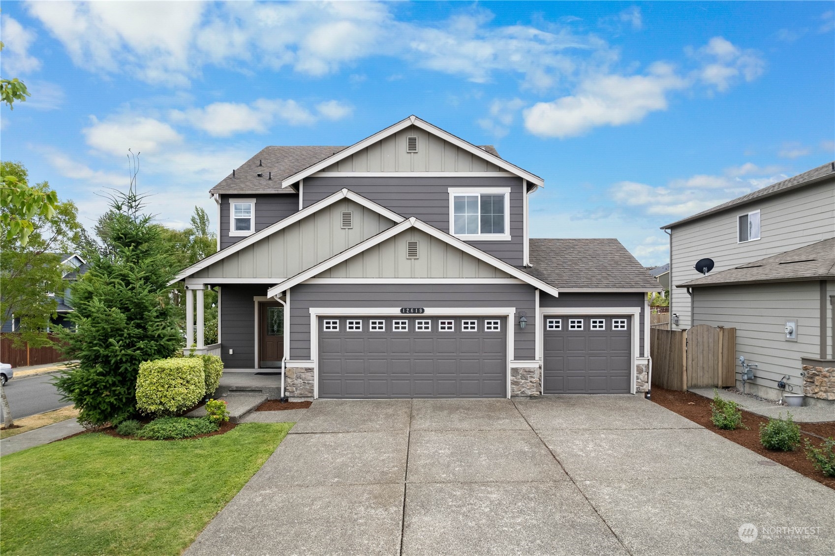 a front view of a house with a yard and garage