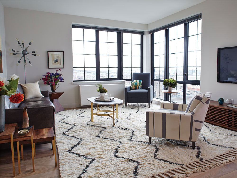 a living room with furniture and a floor to ceiling window