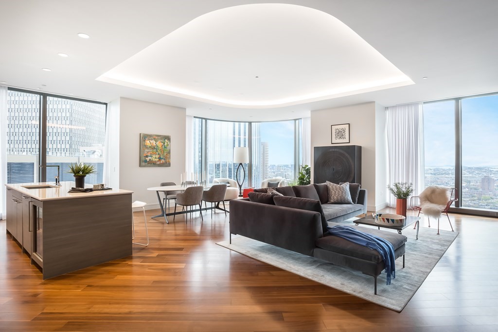 a living room with furniture a large window and a flat screen tv