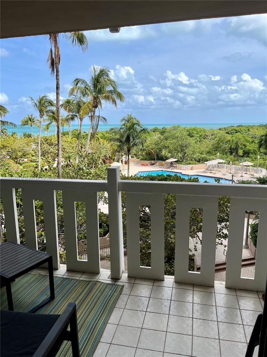 a view of a balcony with two chairs