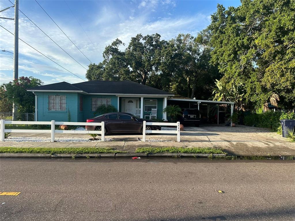 a view of house with swimming pool and a yard