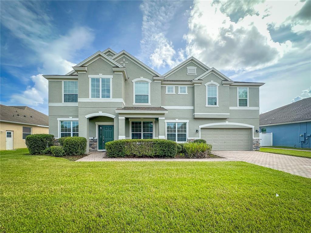 a front view of a house with a yard