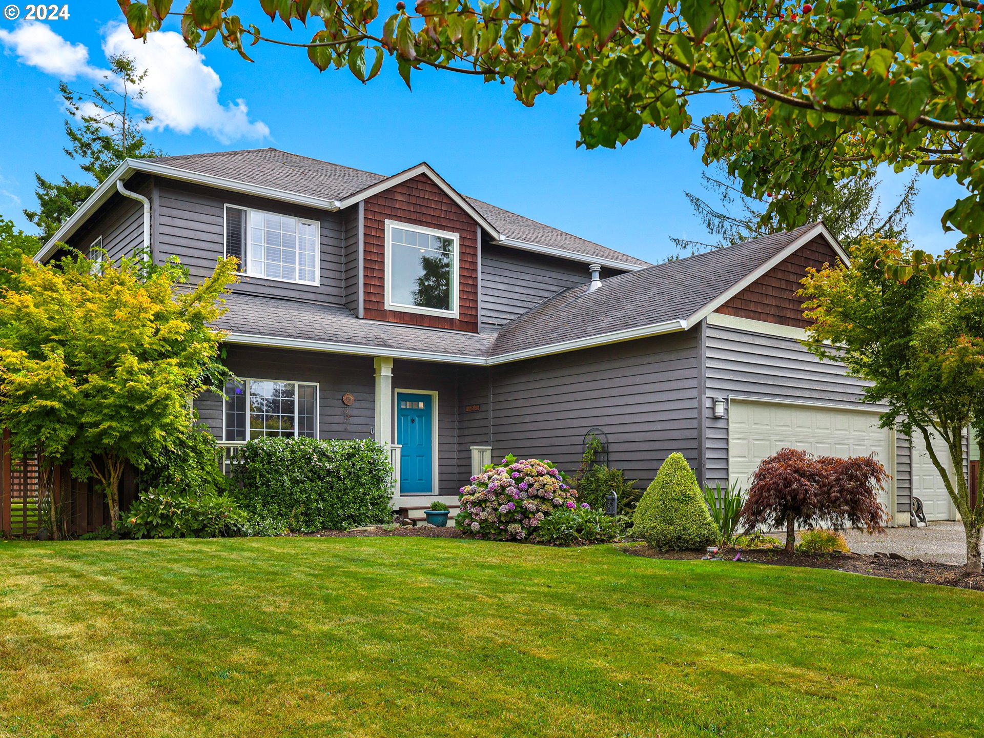 a front view of a house with a garden