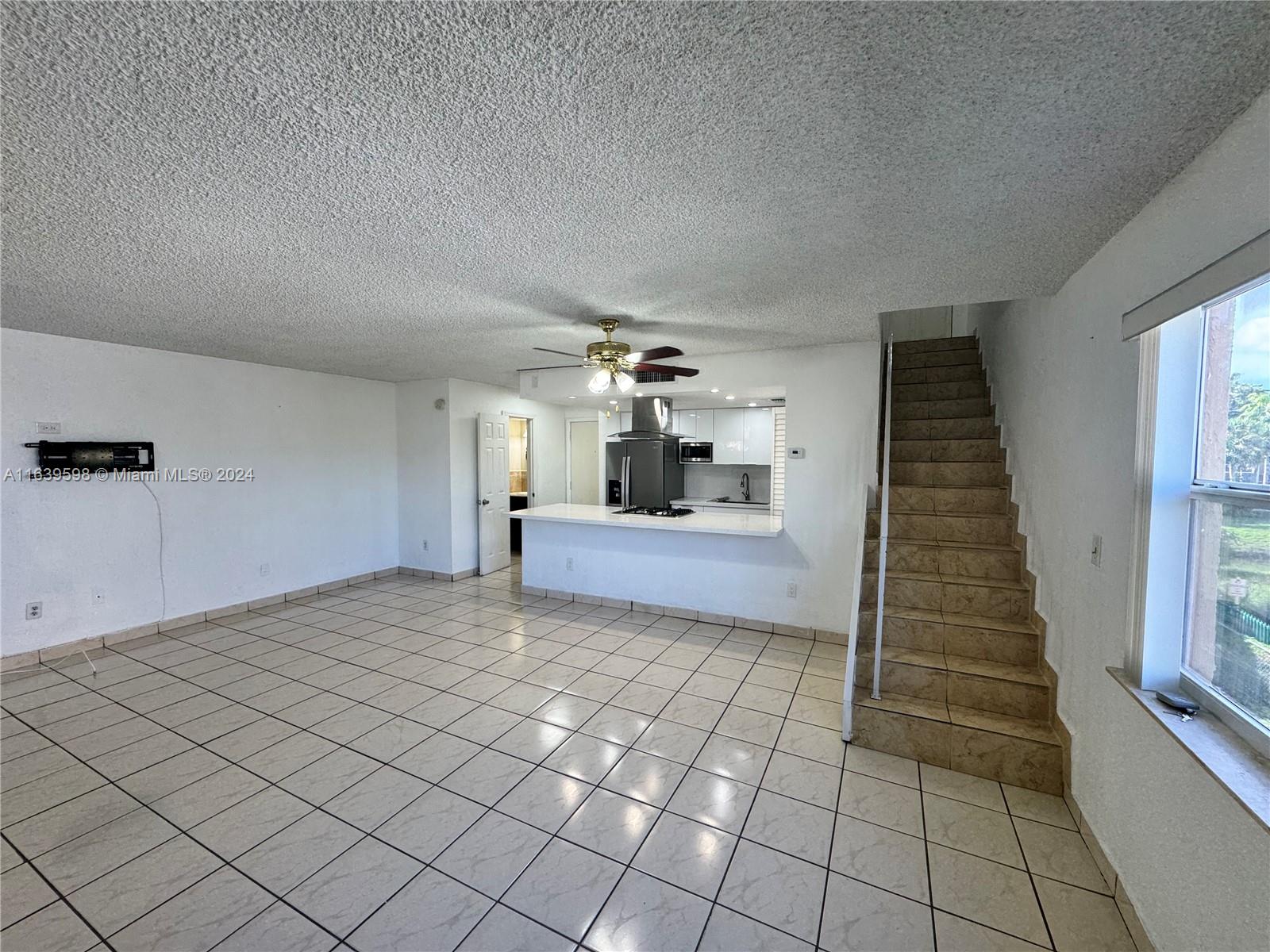 a view of a hallway to room with wooden floor