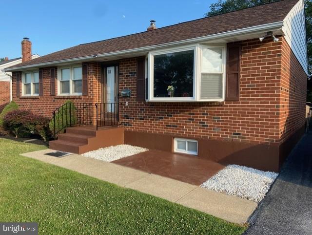 a brick house with a yard potted plants