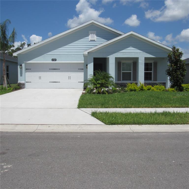 a front view of house with garage and green space