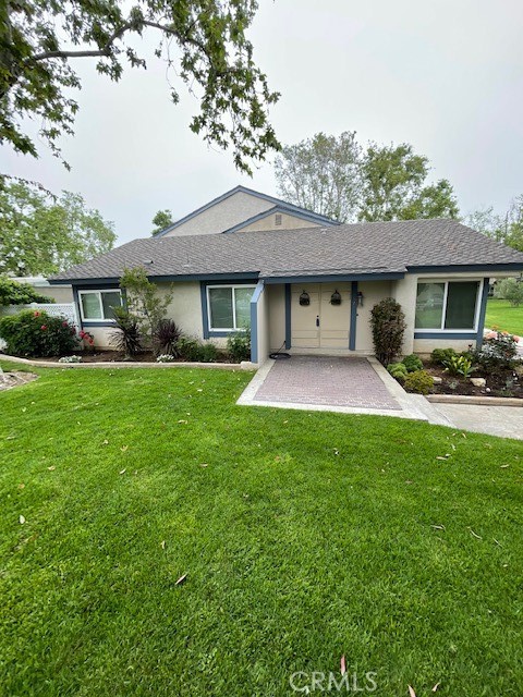 a front view of a house with a garden and yard