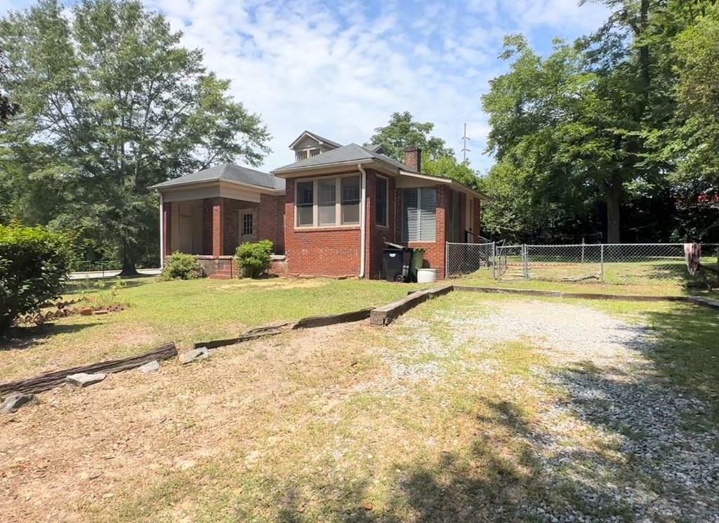 a view of a house with swimming pool and a yard