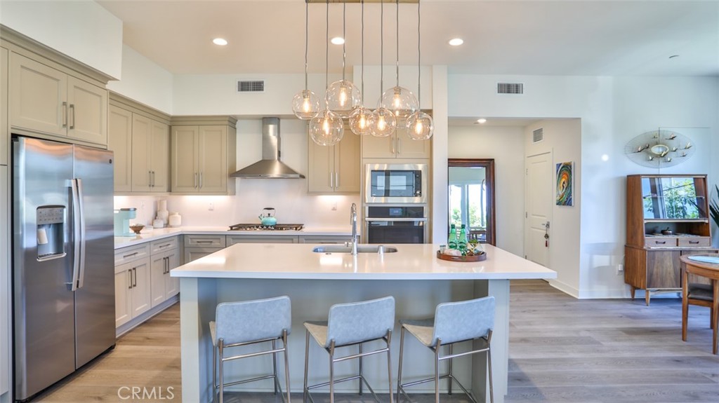 a kitchen with granite countertop a kitchen island and stainless steel appliances