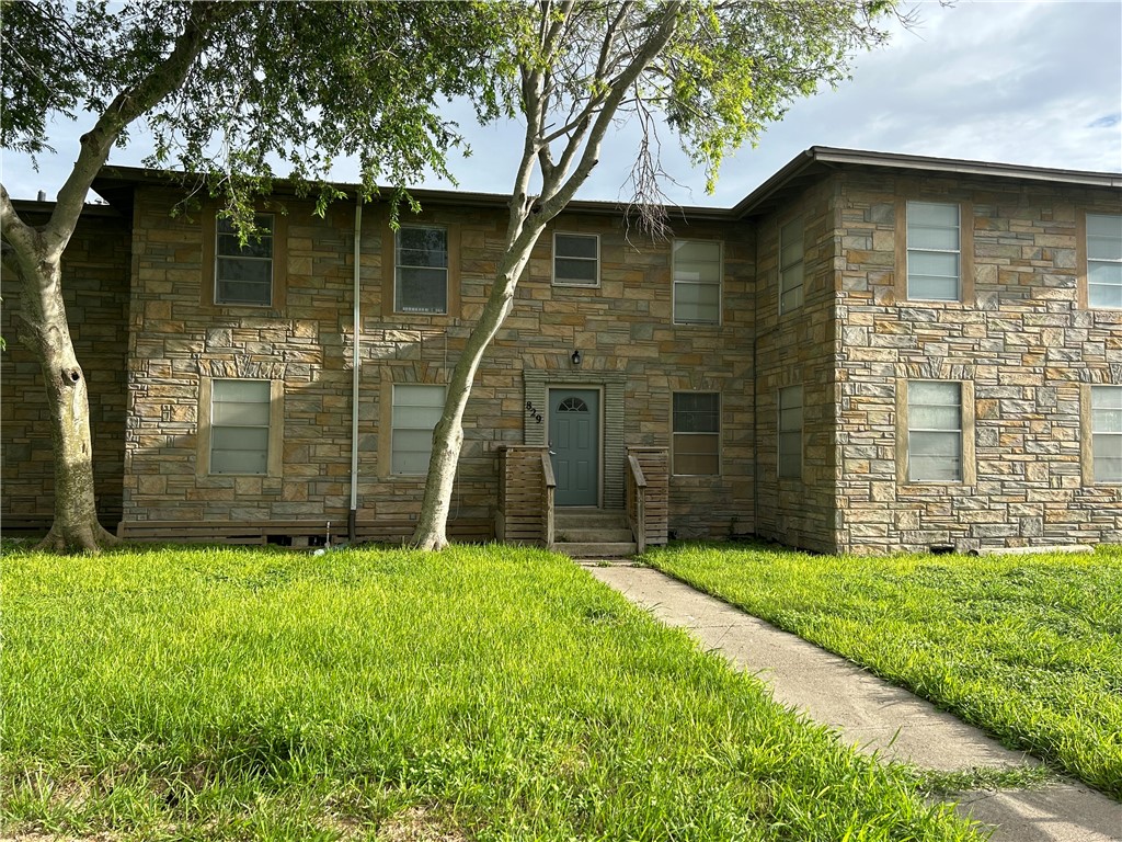 a large stone house with a yard