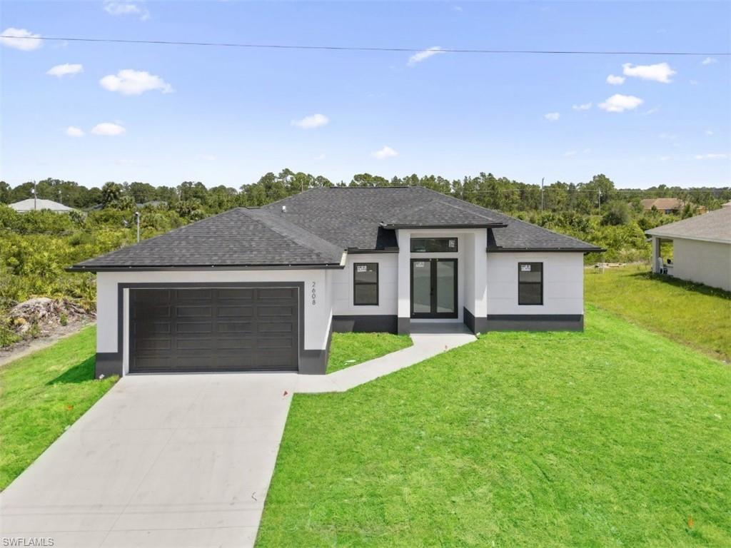 a front view of a house with a yard and garage