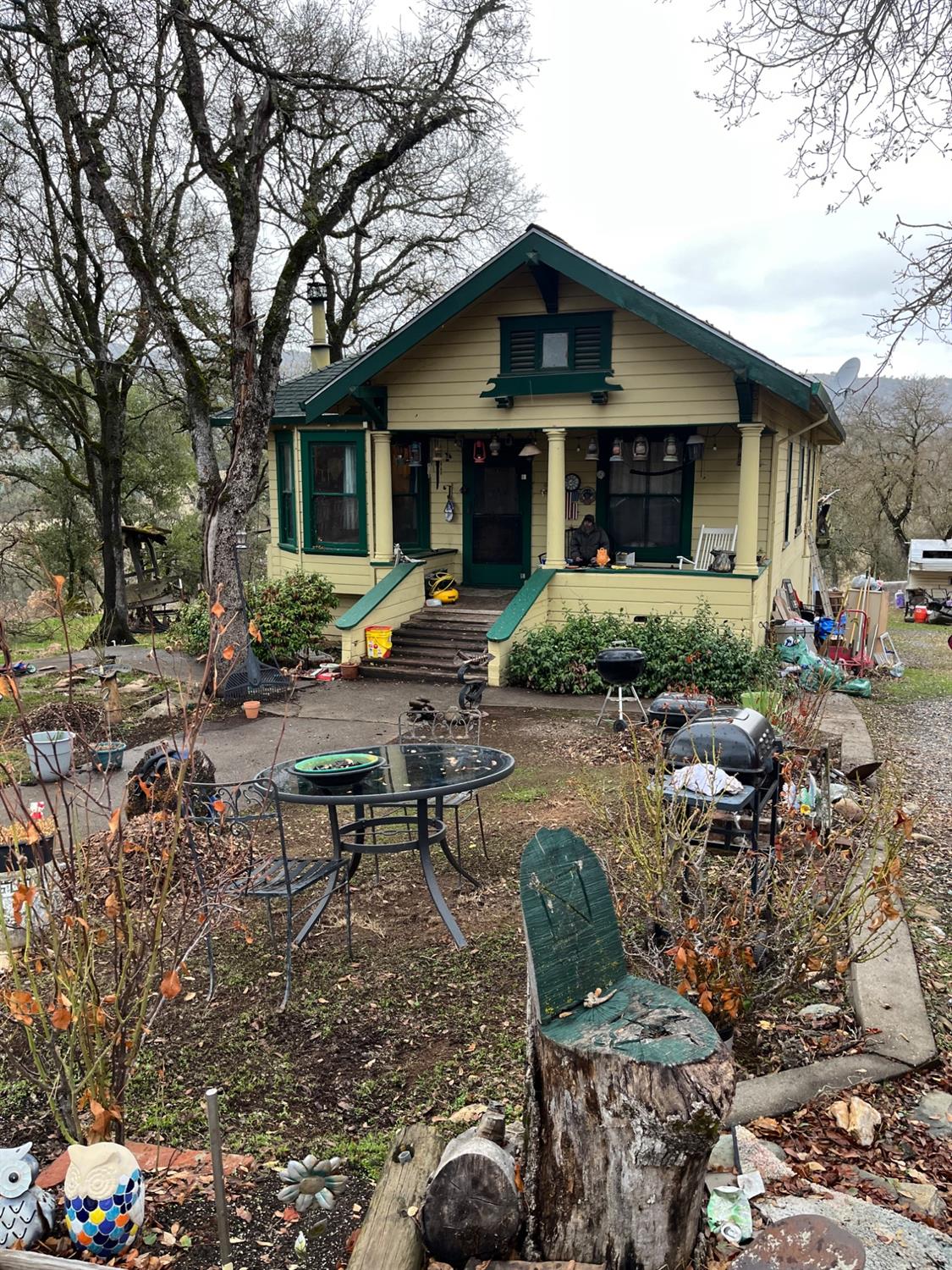 a view of a house with backyard sitting area and garden