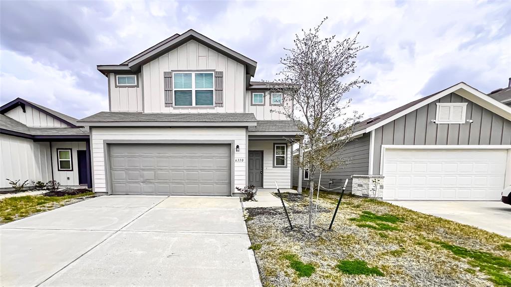 Charming Two-Story Home Facade with Attached Double Garage