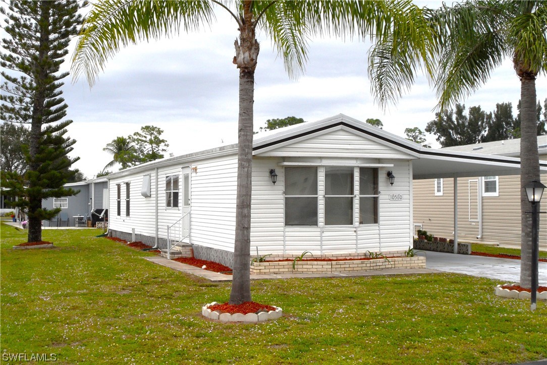 a front view of a house with a garden and yard