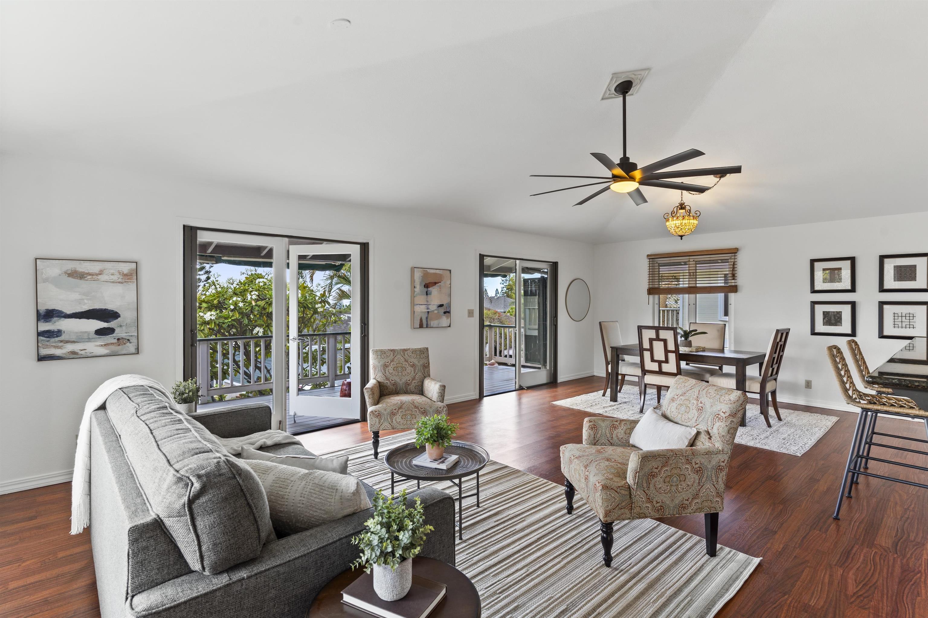 a living room with furniture a chandelier and a window