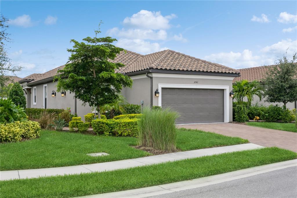 a front view of a house with a yard and garage