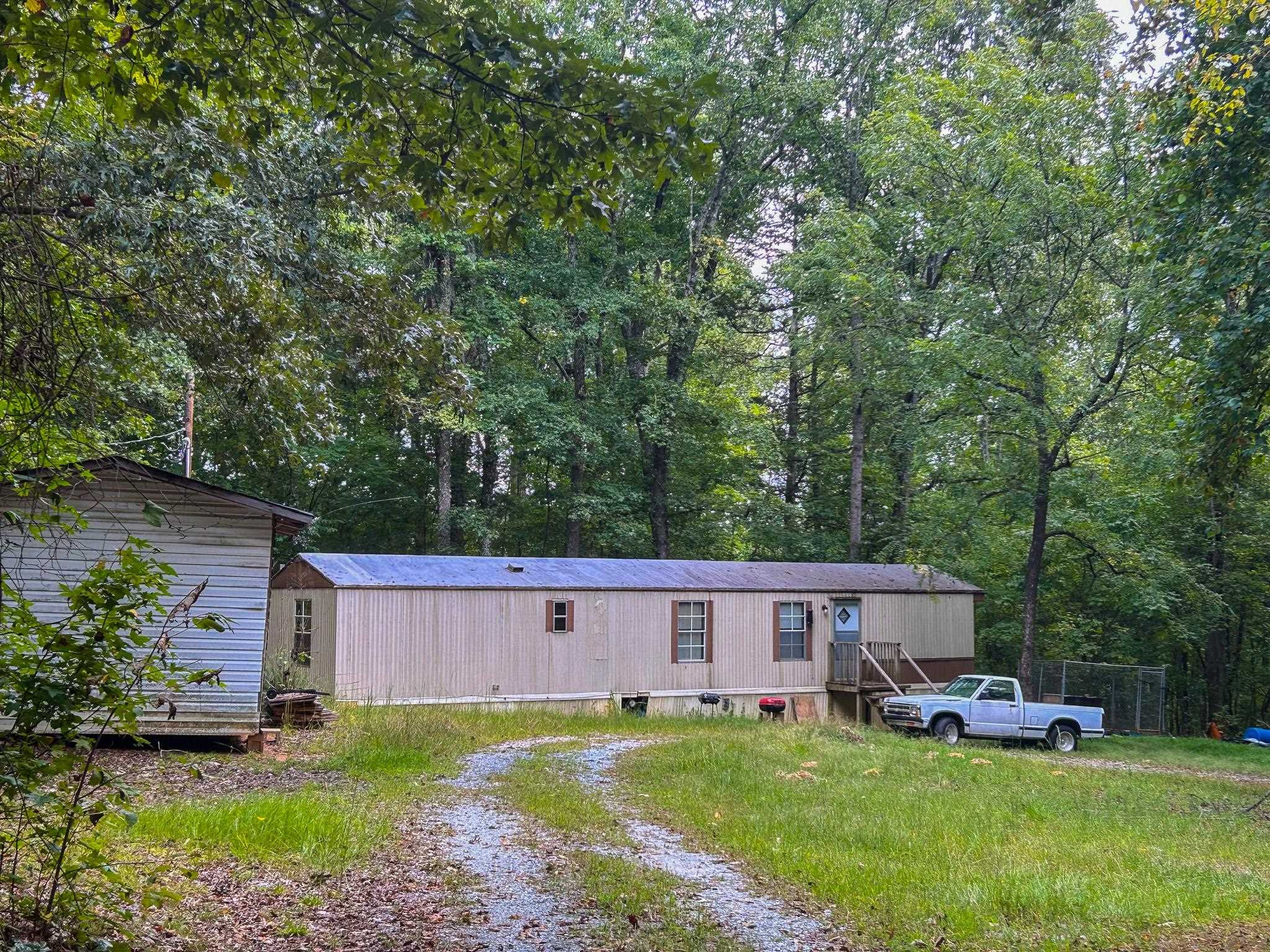 a view of a house with a yard and sitting area