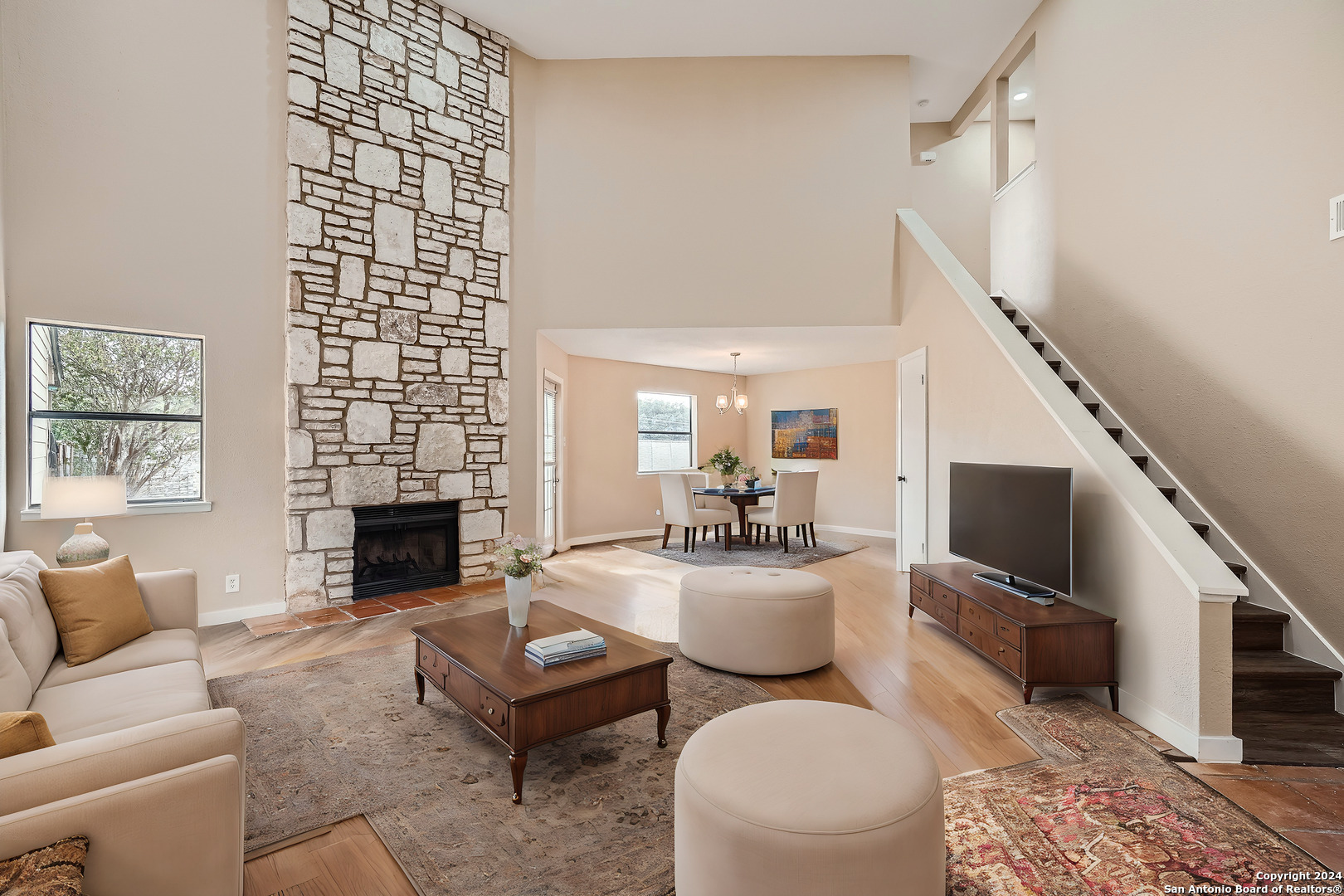 a living room with furniture a rug and a fireplace