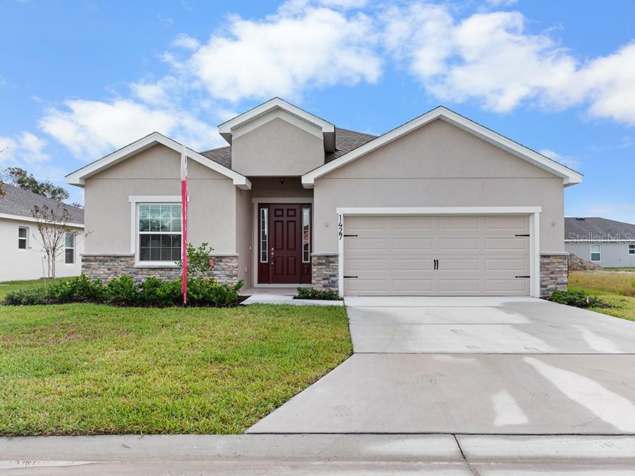 a front view of house with yard and green space