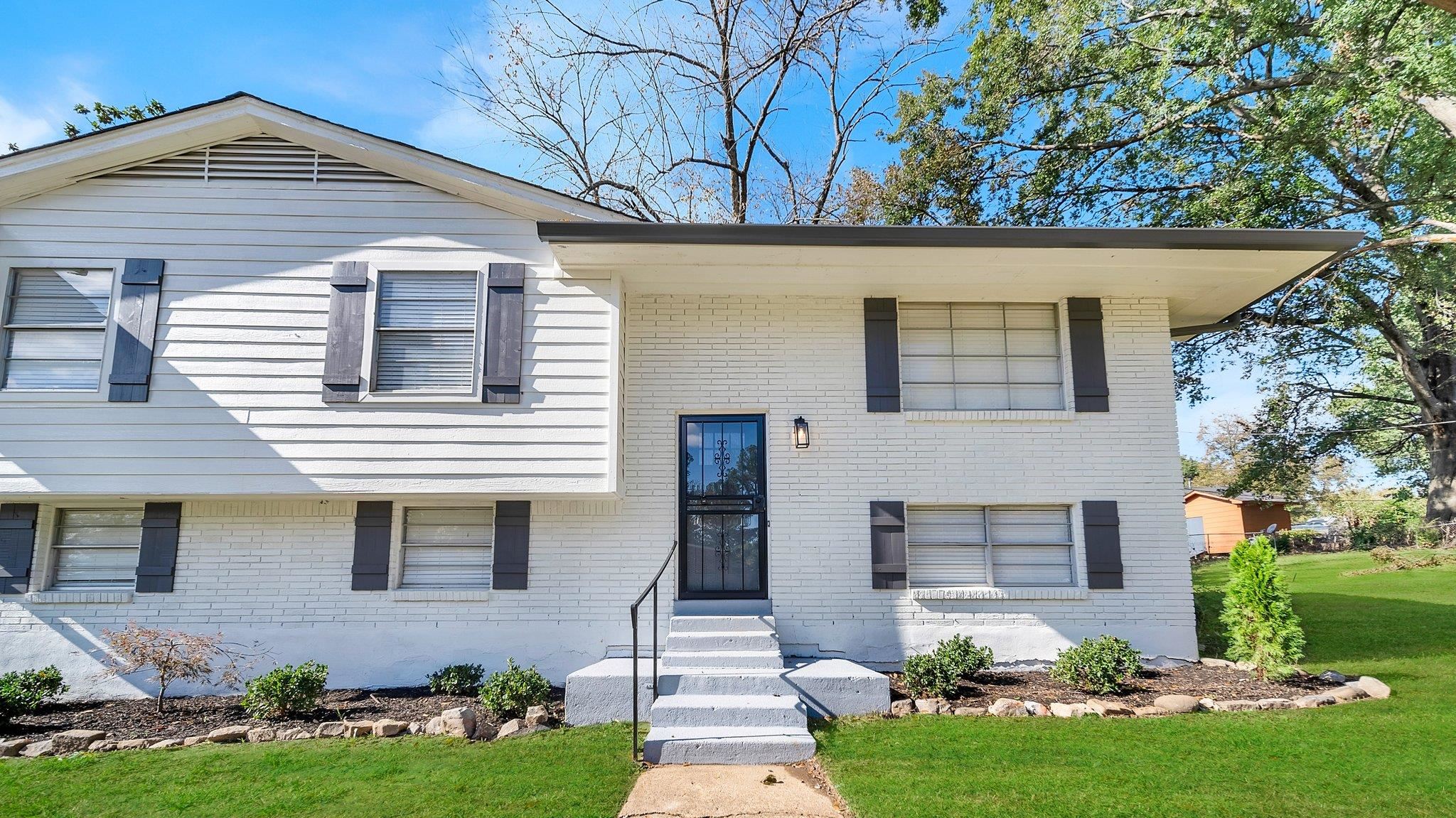 View of front of property with a front yard