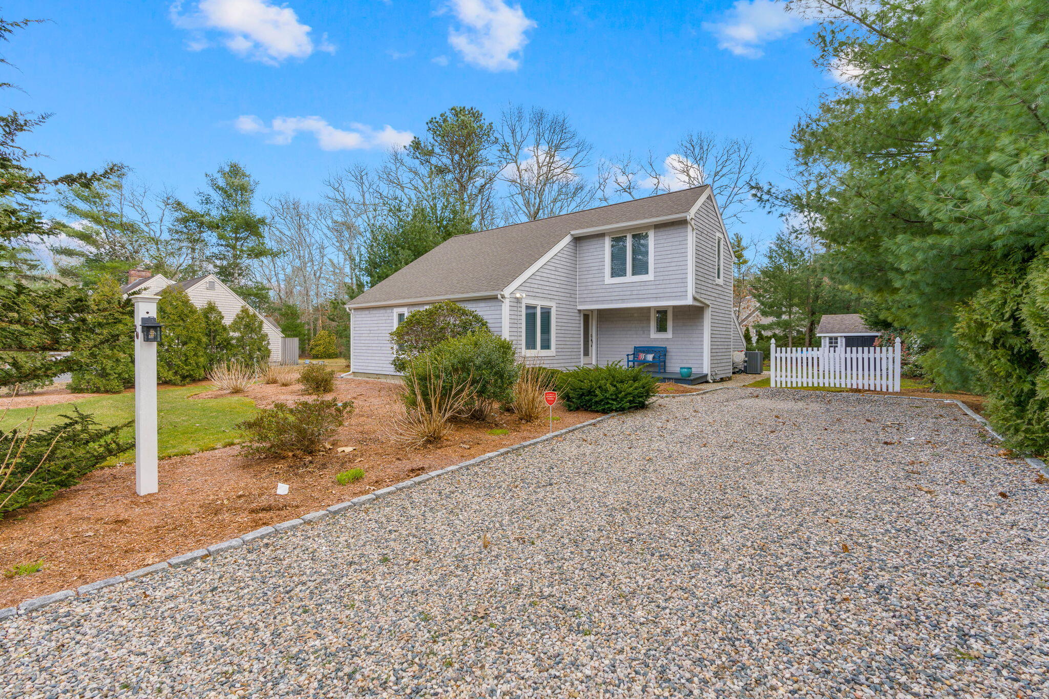 a front view of a house with a yard and tree s