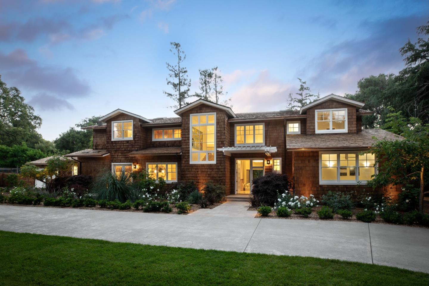 a front view of a house with a garden