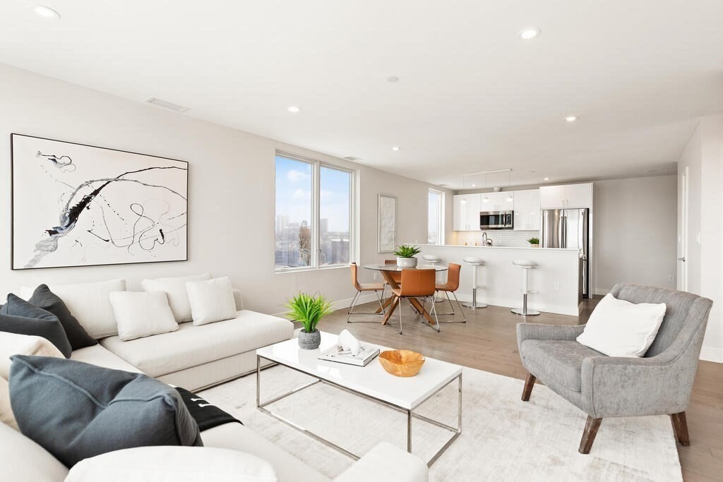 a living room with furniture and kitchen view