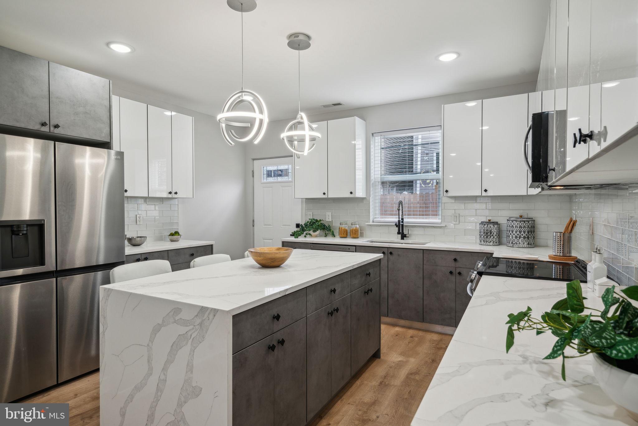 a kitchen with a sink a stove a refrigerator and cabinets