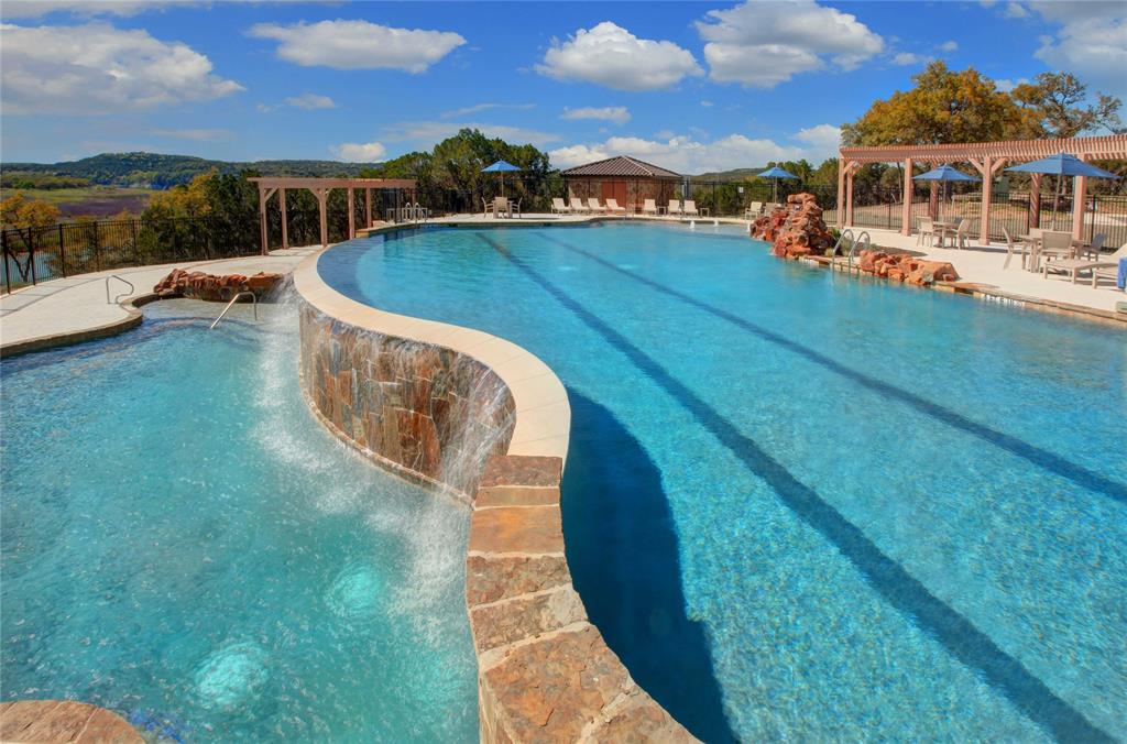 a view of a swimming pool with lawn chairs